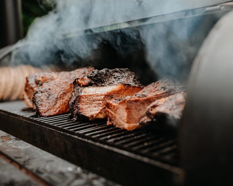 Smoked red meat on grill – part of the supply chain influencing global red meat prices